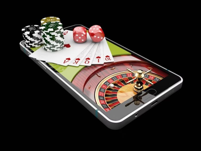 s8toto wap Olympic Games sportsbook section displayed on a mobile phone alongside live blackjack table